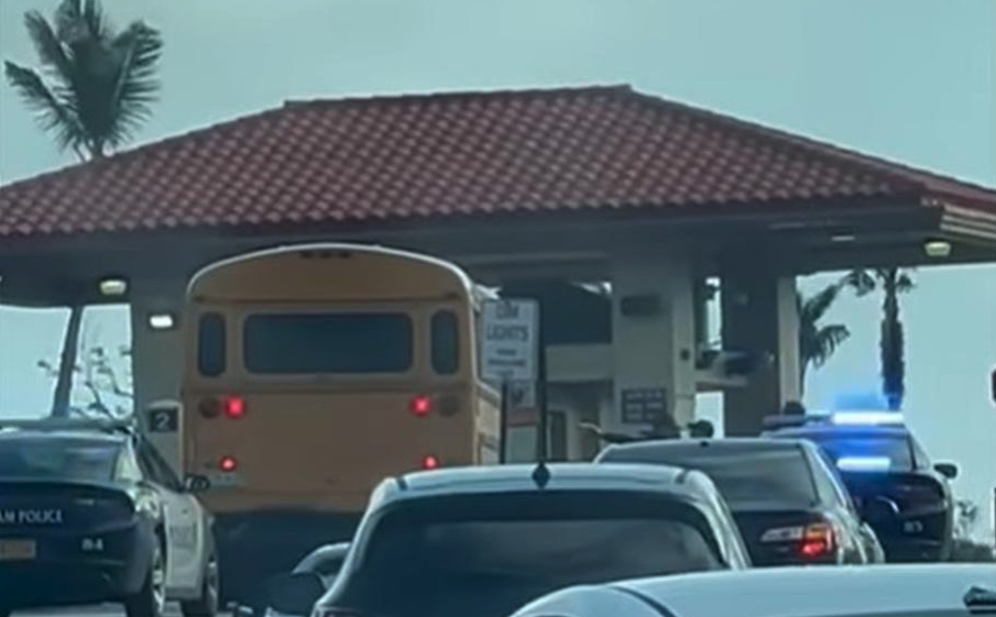 A police officer appears to draw a weapon at the driver of a stolen bus near Andersen Air Force Base, Guam, in this screenshot of a video posted by the 36th Wing commander.